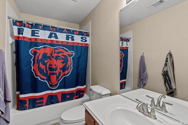 full bathroom featuring visible vents, toilet, shower / bath combo with shower curtain, a textured wall, and vanity