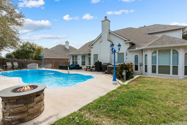 view of pool featuring a fenced in pool, a fire pit, a fenced backyard, a yard, and a patio