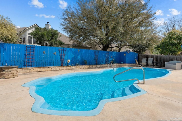 view of pool with a patio area, a fenced backyard, and a fenced in pool