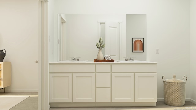 full bathroom with double vanity, baseboards, and a sink