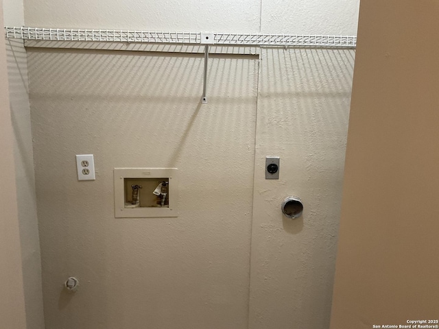 laundry area featuring electric dryer hookup, gas dryer hookup, hookup for a washing machine, laundry area, and a textured wall