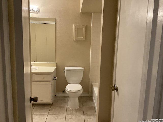 bathroom with tile patterned flooring, toilet, and vanity