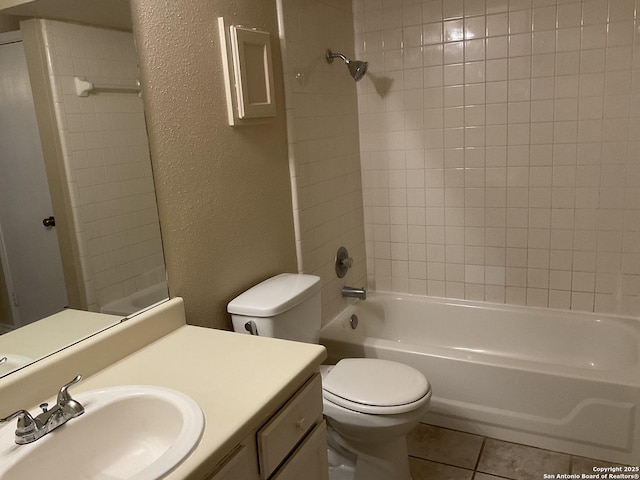 bathroom featuring a textured wall, toilet, washtub / shower combination, and tile patterned flooring