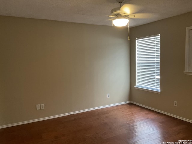 spare room with wood finished floors, baseboards, and ceiling fan