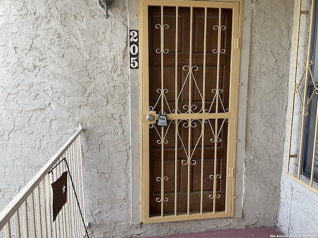 property entrance with stucco siding