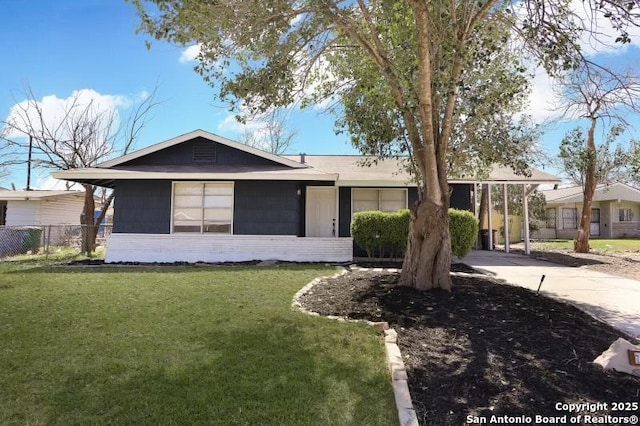 single story home featuring a front lawn, fence, and brick siding