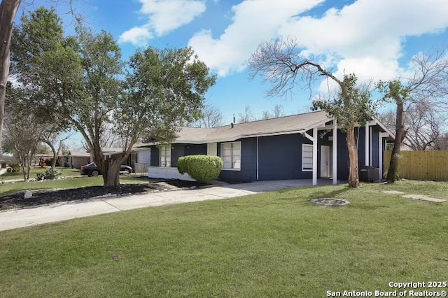 ranch-style house with a front yard and fence