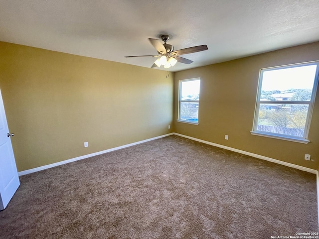 unfurnished room featuring baseboards, carpet, and a ceiling fan