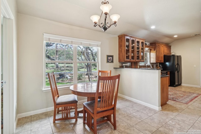 dining space featuring baseboards, visible vents, lofted ceiling, recessed lighting, and a chandelier