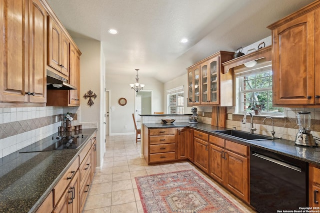 kitchen featuring under cabinet range hood, a peninsula, a notable chandelier, black appliances, and a sink