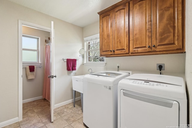 laundry room with baseboards, cabinet space, independent washer and dryer, and light tile patterned flooring