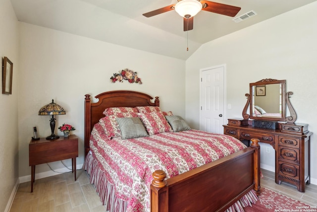 bedroom with visible vents, lofted ceiling, baseboards, and ceiling fan