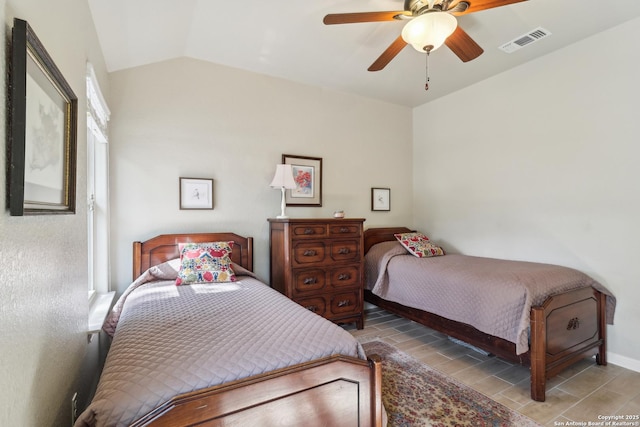 bedroom with wood finish floors, visible vents, lofted ceiling, and ceiling fan