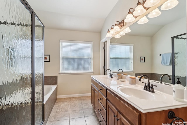 bathroom with tile patterned flooring, lofted ceiling, a bath, and a sink