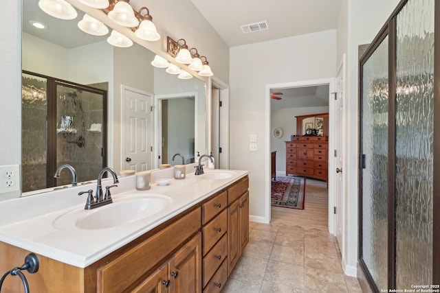 full bath featuring a sink, visible vents, double vanity, and a shower stall