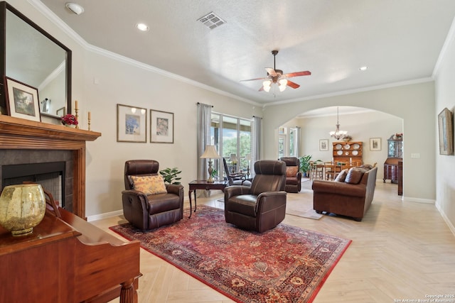 living room featuring visible vents, crown molding, baseboards, a tile fireplace, and arched walkways