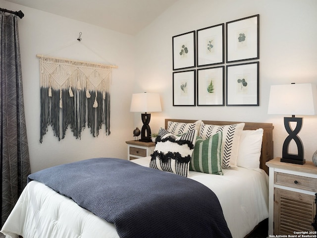 bedroom with lofted ceiling