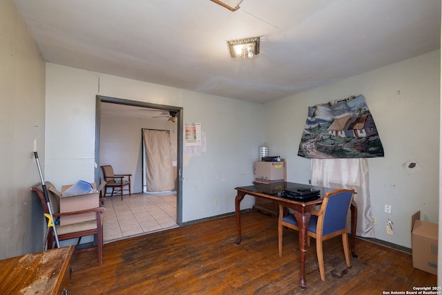 home office with hardwood / wood-style floors and baseboards