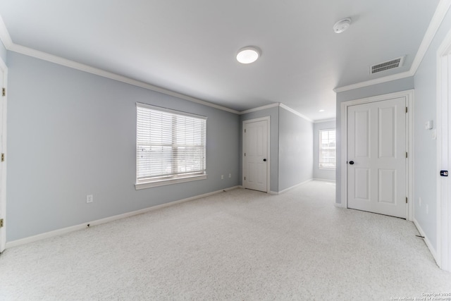 unfurnished room featuring visible vents, baseboards, and ornamental molding