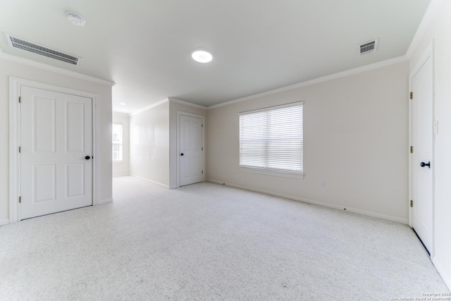 unfurnished bedroom featuring visible vents, baseboards, and ornamental molding