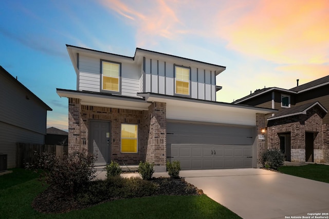 modern home with a garage, brick siding, board and batten siding, and concrete driveway