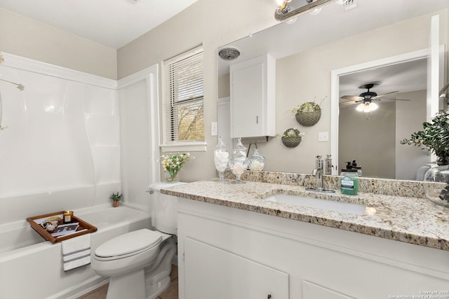 full bath featuring vanity, bathing tub / shower combination, toilet, and a ceiling fan