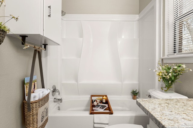 full bathroom featuring toilet, vanity, and bathtub / shower combination