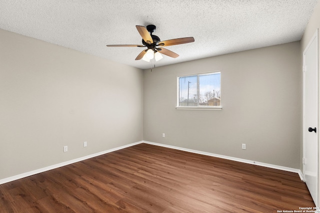 unfurnished room with a textured ceiling, a ceiling fan, baseboards, and wood finished floors