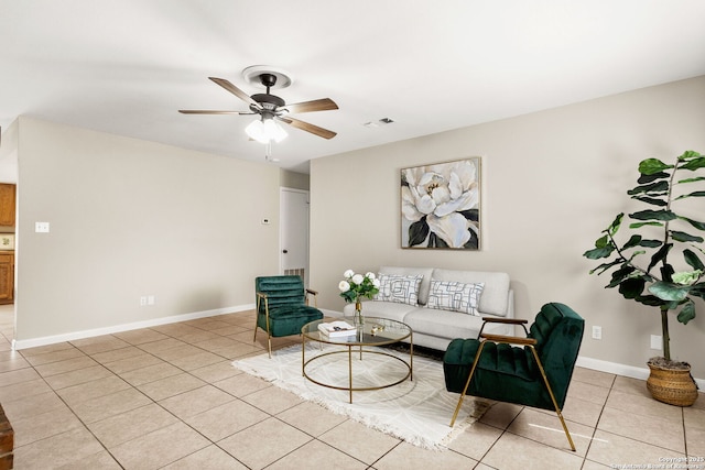 living area featuring visible vents, light tile patterned floors, a ceiling fan, and baseboards