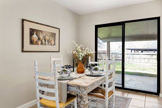 dining room with light tile patterned floors and baseboards