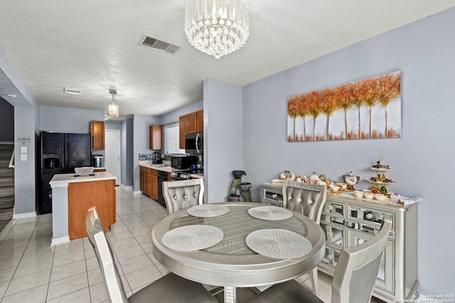 dining space with visible vents, baseboards, a notable chandelier, and a textured ceiling