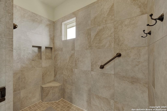 interior details with a tile shower