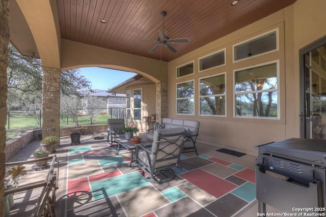 view of patio / terrace with a ceiling fan and fence