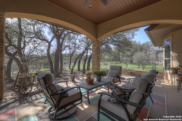 view of patio / terrace with ceiling fan, fence, and an outdoor hangout area