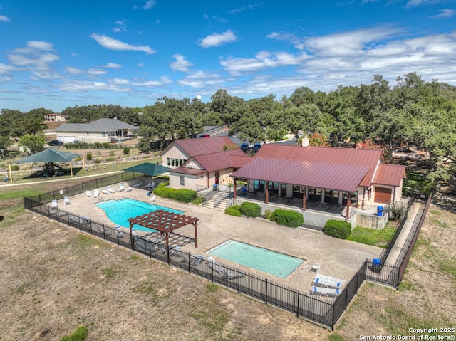 community pool with a patio area and fence