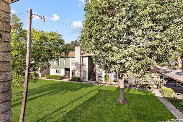 view of front of property with a chimney and a front yard