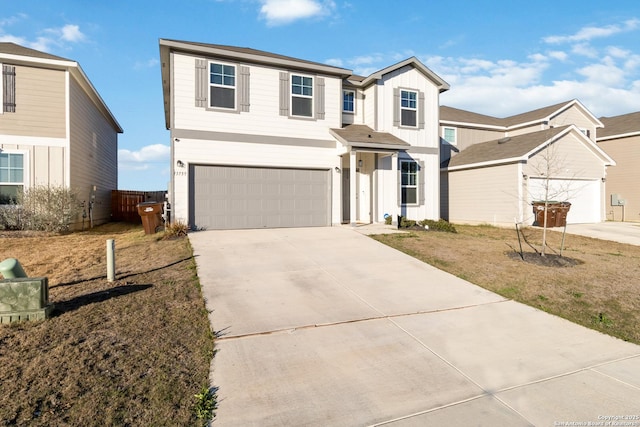 traditional-style house with concrete driveway, an attached garage, fence, and board and batten siding