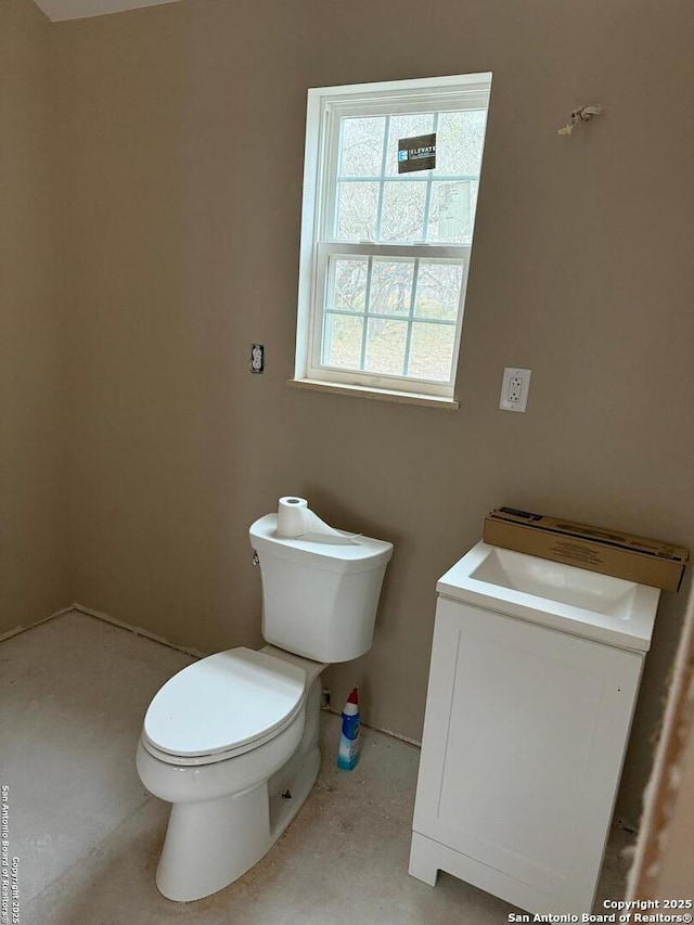 bathroom featuring toilet and vanity