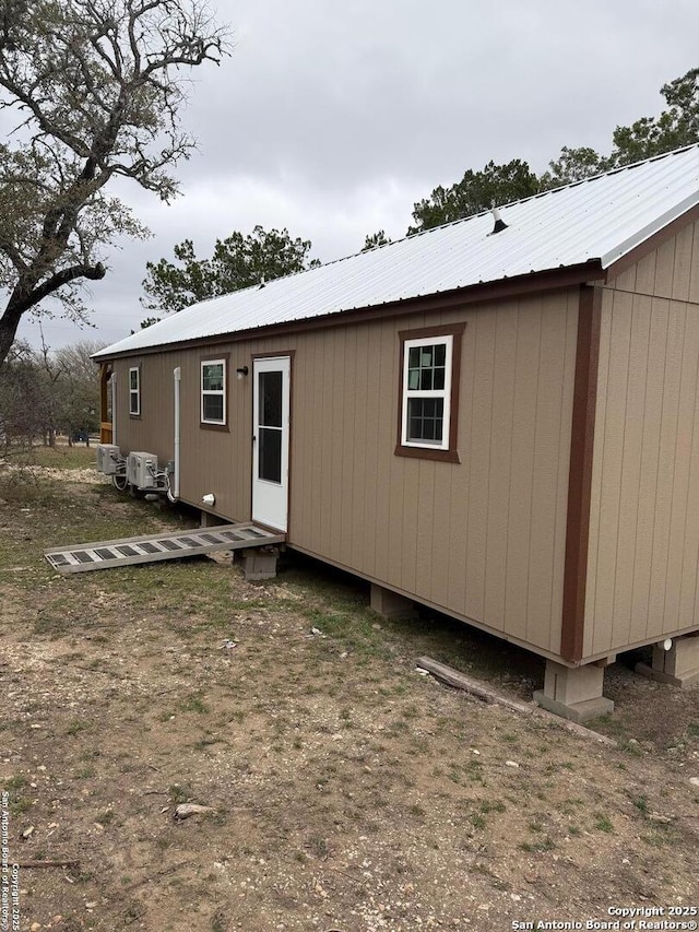 rear view of house featuring metal roof