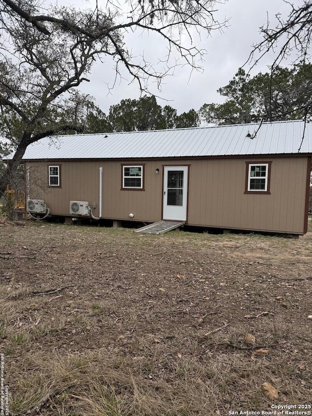 view of front of home with ac unit and metal roof