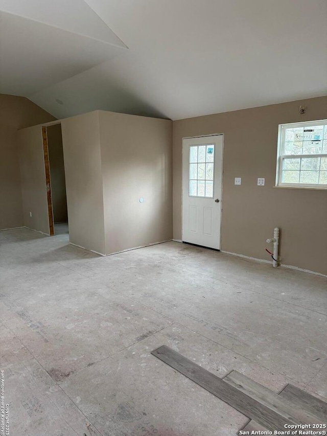 spare room with lofted ceiling