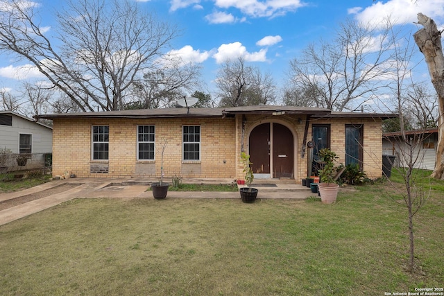 single story home featuring a front yard, fence, and brick siding