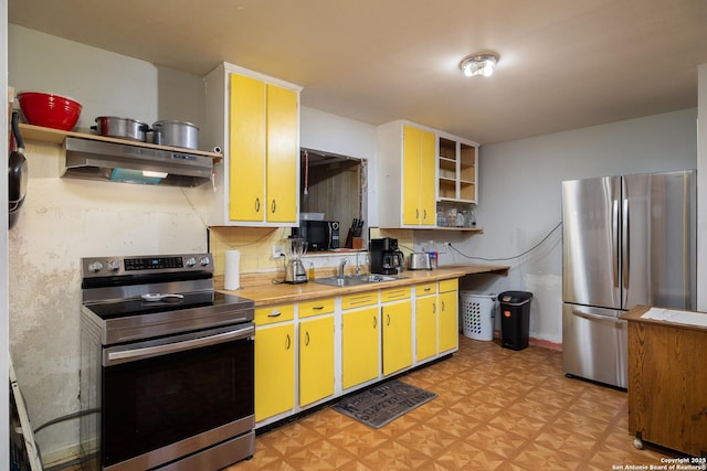 kitchen with under cabinet range hood, light floors, stainless steel appliances, and open shelves