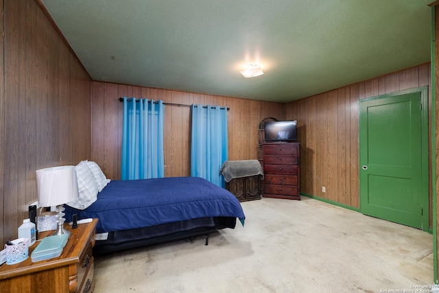 bedroom featuring carpet and wood walls