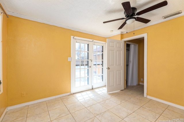 unfurnished room featuring ceiling fan, visible vents, baseboards, and ornamental molding