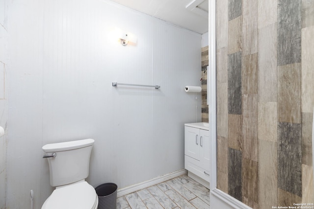 bathroom featuring toilet, baseboards, marble finish floor, and a shower