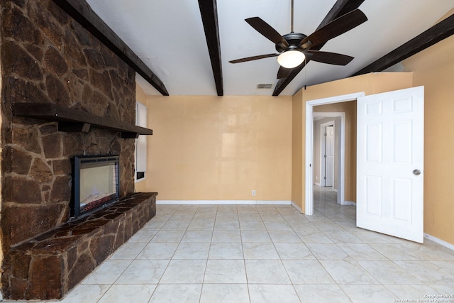 unfurnished living room featuring beamed ceiling, visible vents, a fireplace, baseboards, and ceiling fan