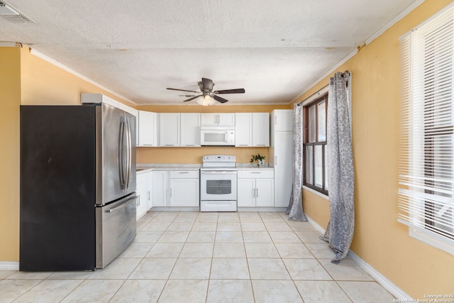 kitchen featuring white appliances, visible vents, light countertops, white cabinets, and crown molding