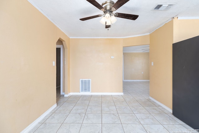 unfurnished room with crown molding, arched walkways, and visible vents