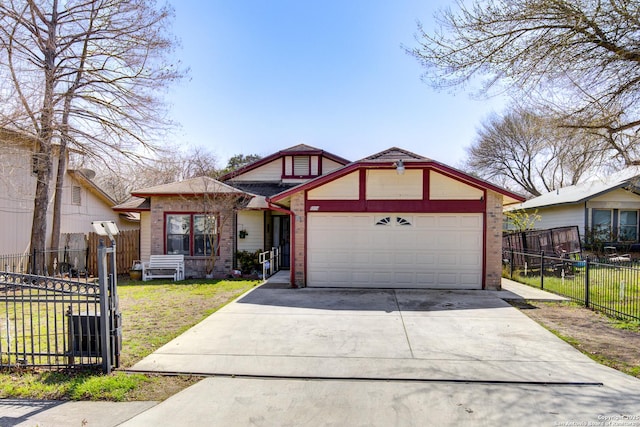 view of front of home with a front lawn, driveway, fence, a garage, and brick siding